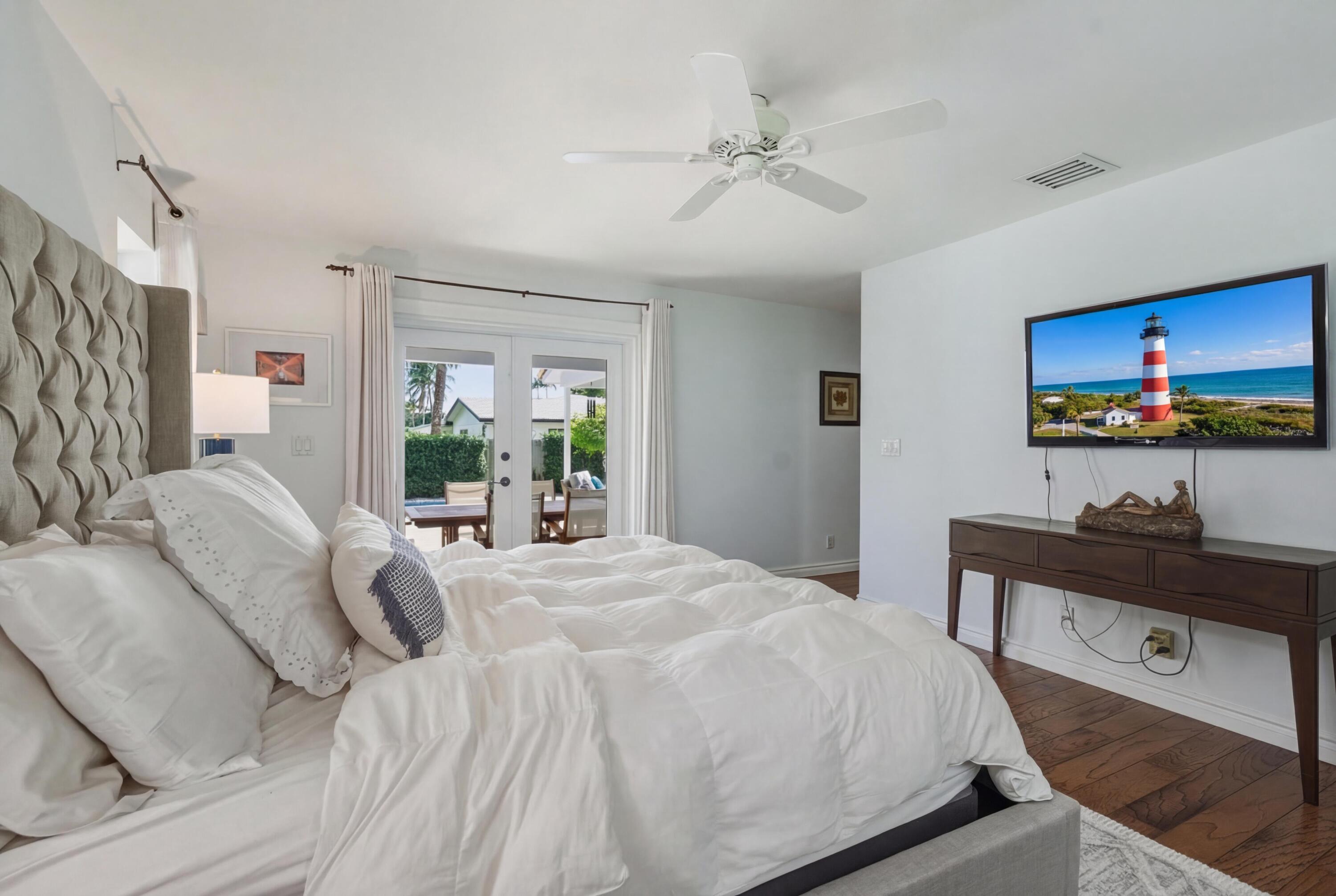 2642 Northeast 26th Terrace Lighthouse Point, FL 33064 - Photo 17 of 53 a bedroom with a bed and a table in it
