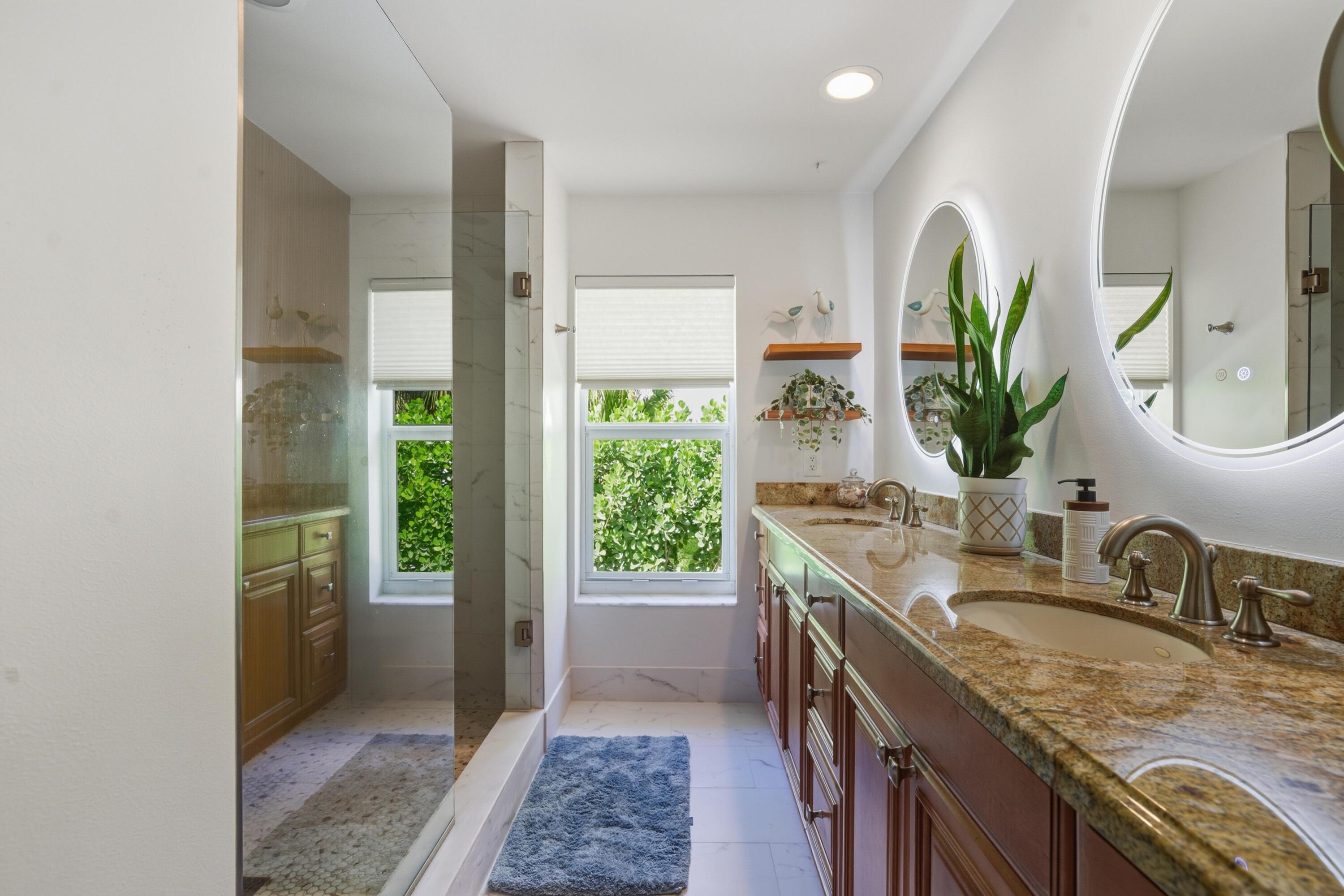 2642 Northeast 26th Terrace Lighthouse Point, FL 33064 - Photo 20 of 53 a bathroom with sink and mirror