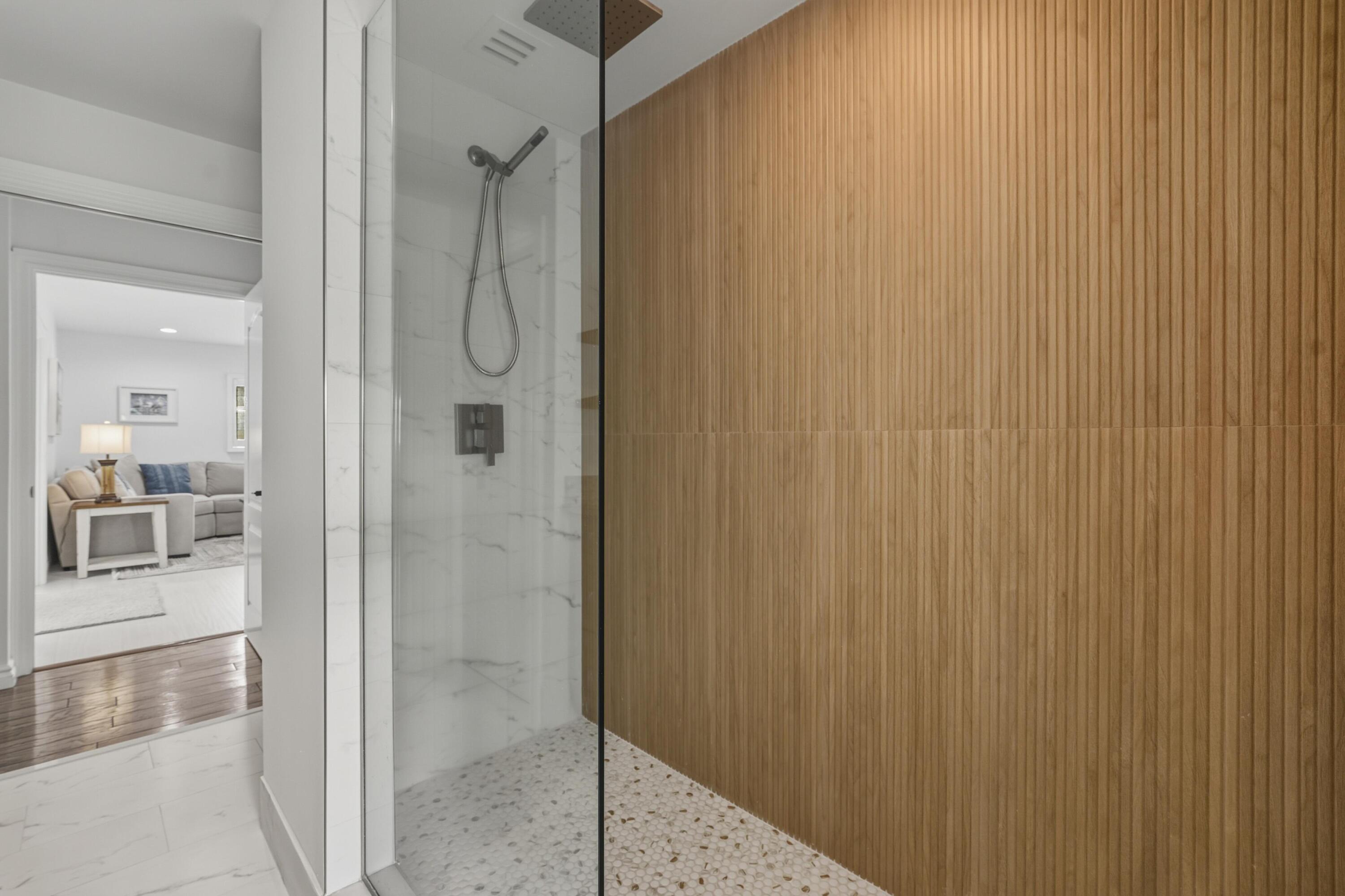 2642 Northeast 26th Terrace Lighthouse Point, FL 33064 - Photo 22 of 53 a bathroom with a glass shower door and a bathroom