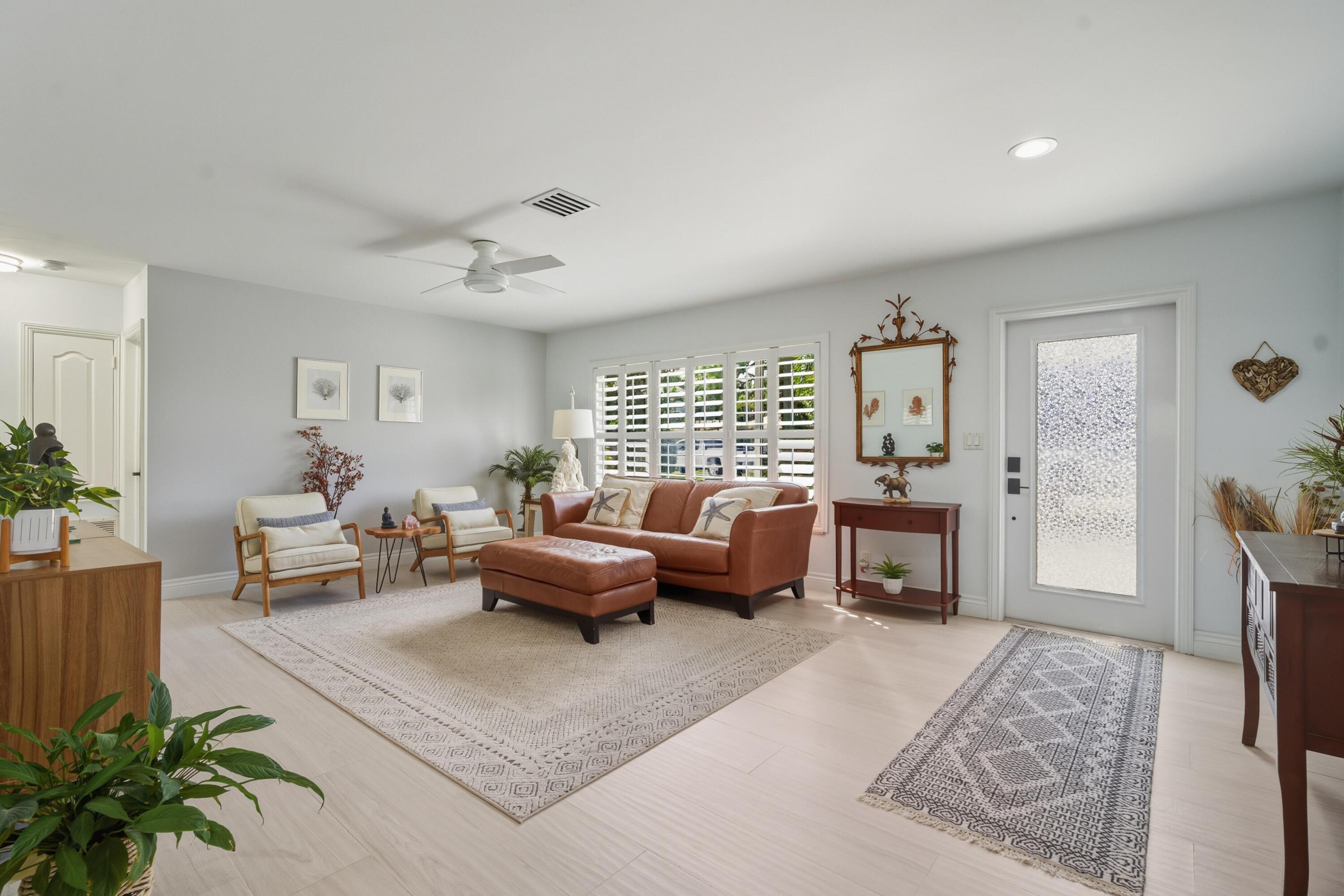 2642 Northeast 26th Terrace Lighthouse Point, FL 33064 - Photo 24 of 53 a living room with furniture and a fireplace