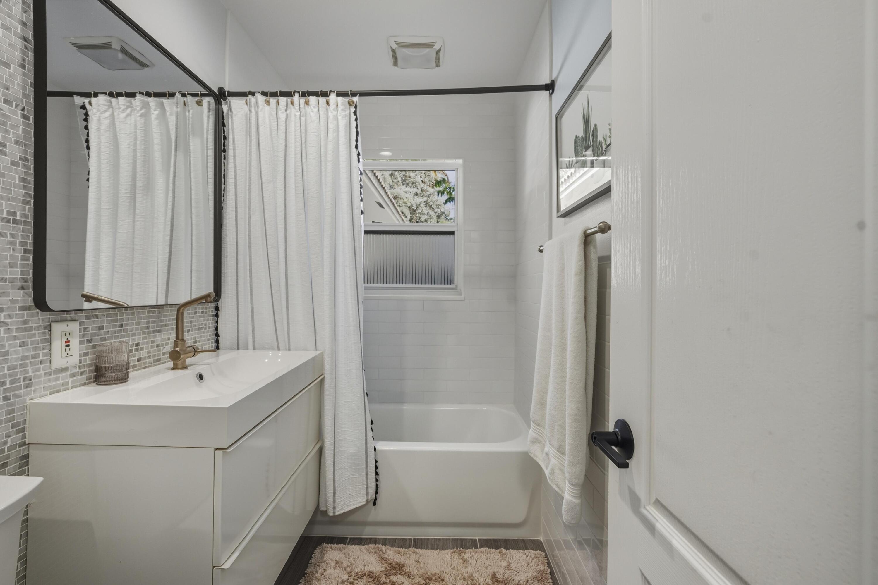 2642 Northeast 26th Terrace Lighthouse Point, FL 33064 - Photo 39 of 53 a bathroom with a sink a toilet and shower