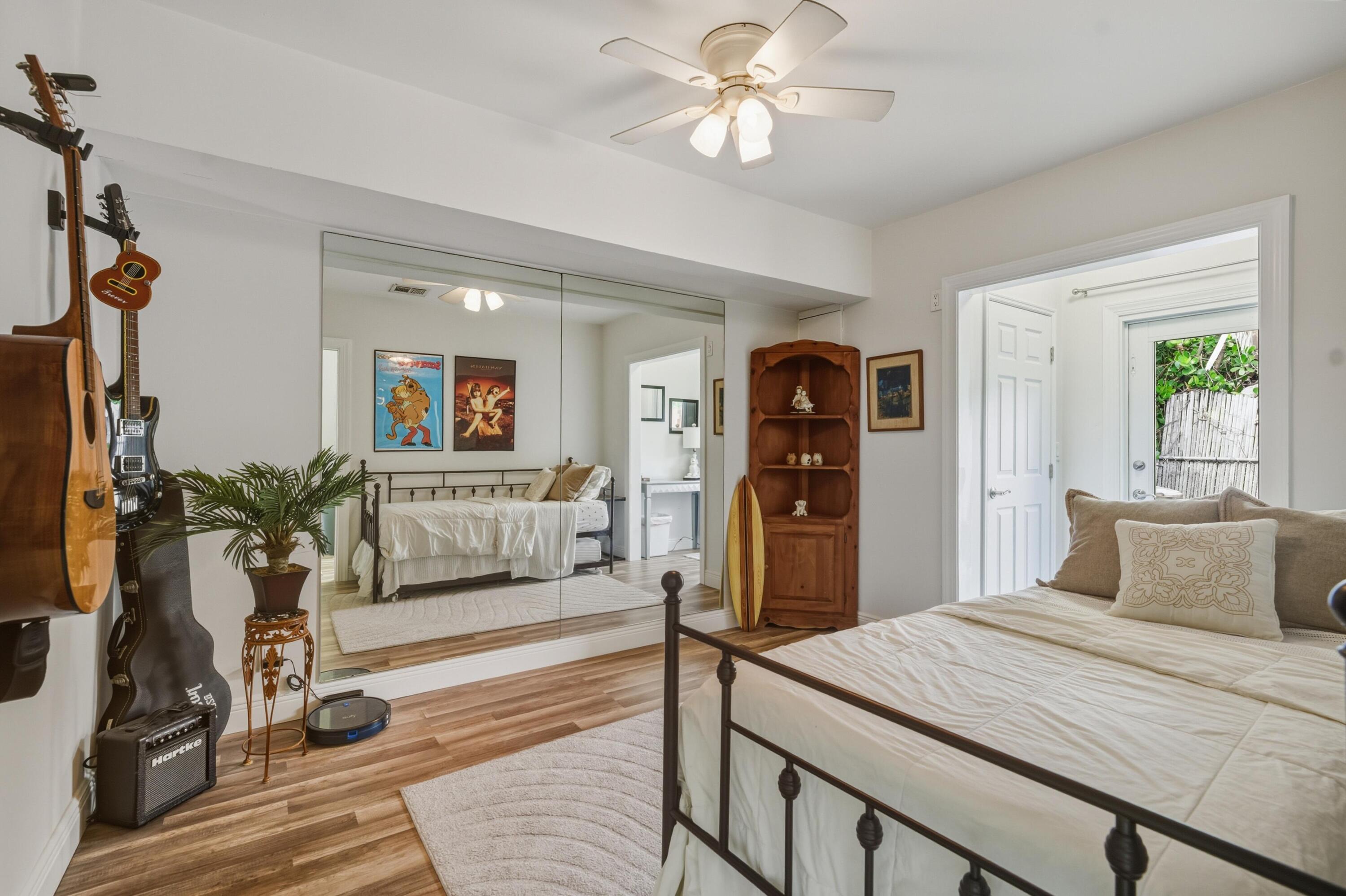 2642 Northeast 26th Terrace Lighthouse Point, FL 33064 - Photo 43 of 53 a bedroom with a large bed and a chandelier