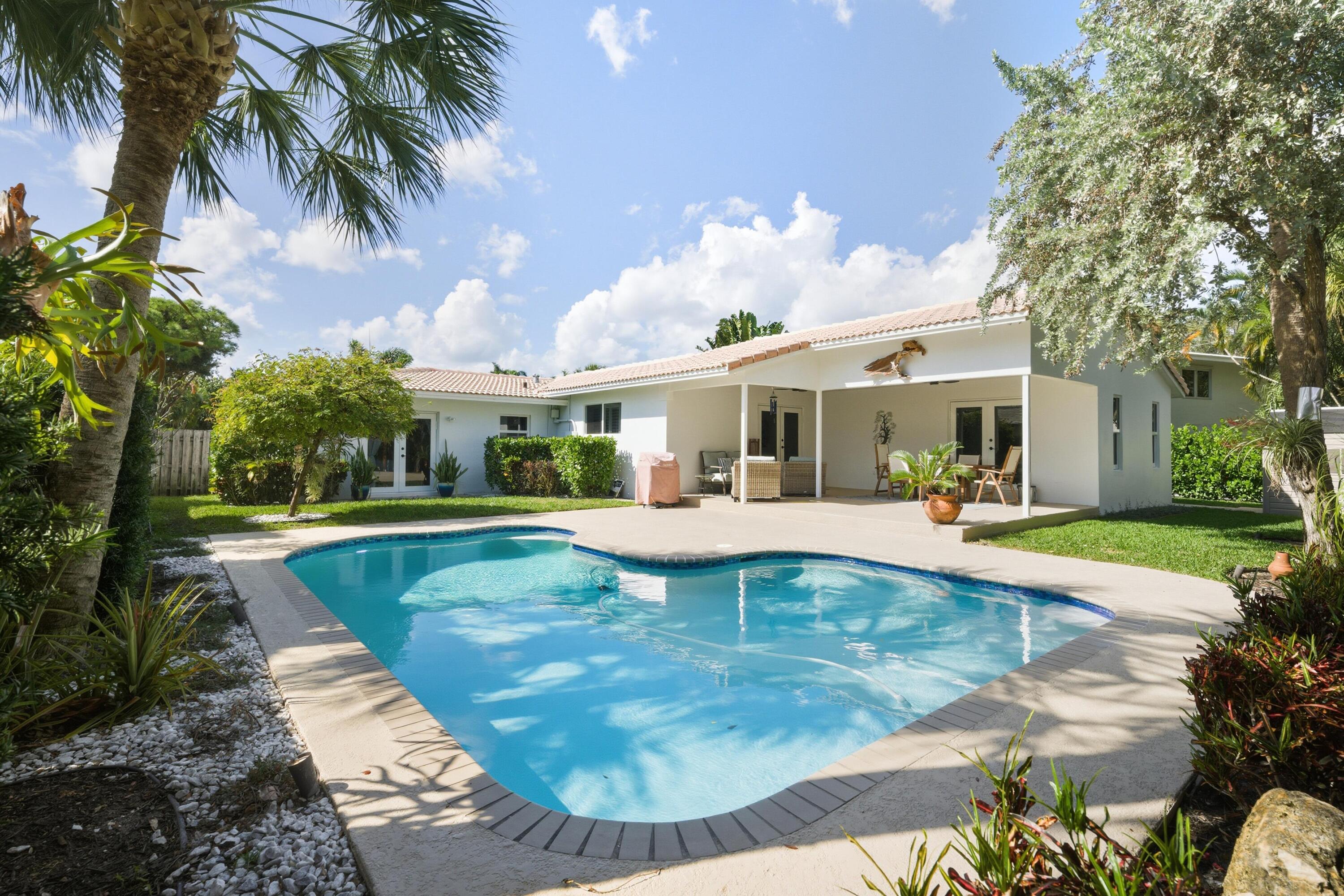 2642 Northeast 26th Terrace Lighthouse Point, FL 33064 - Photo 7 of 53 a view of a house with swimming pool and sitting area