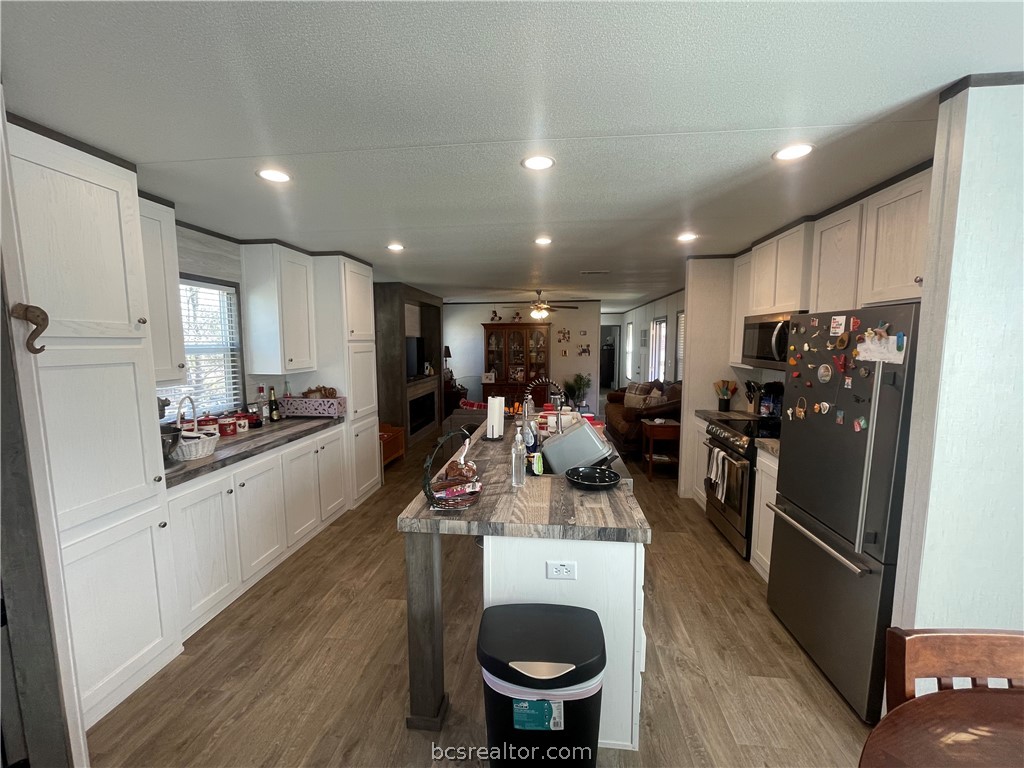 11320 Old Hearne Road Bryan, TX 77807 - Photo 2 of 26 a kitchen with a sink a stove and refrigerator