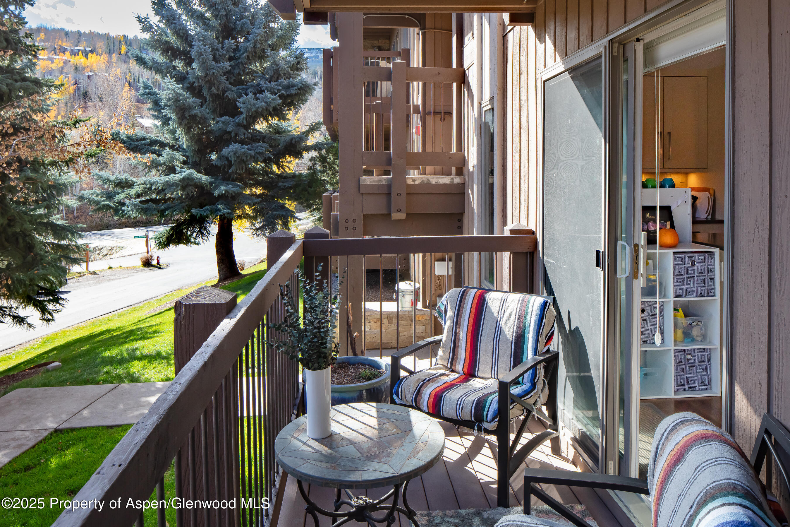 35 Upper Woodbridge Road, Unit 28A Snowmass Village, CO 81615 - Photo 13 of 13 a balcony with couple of chairs and wooden fence