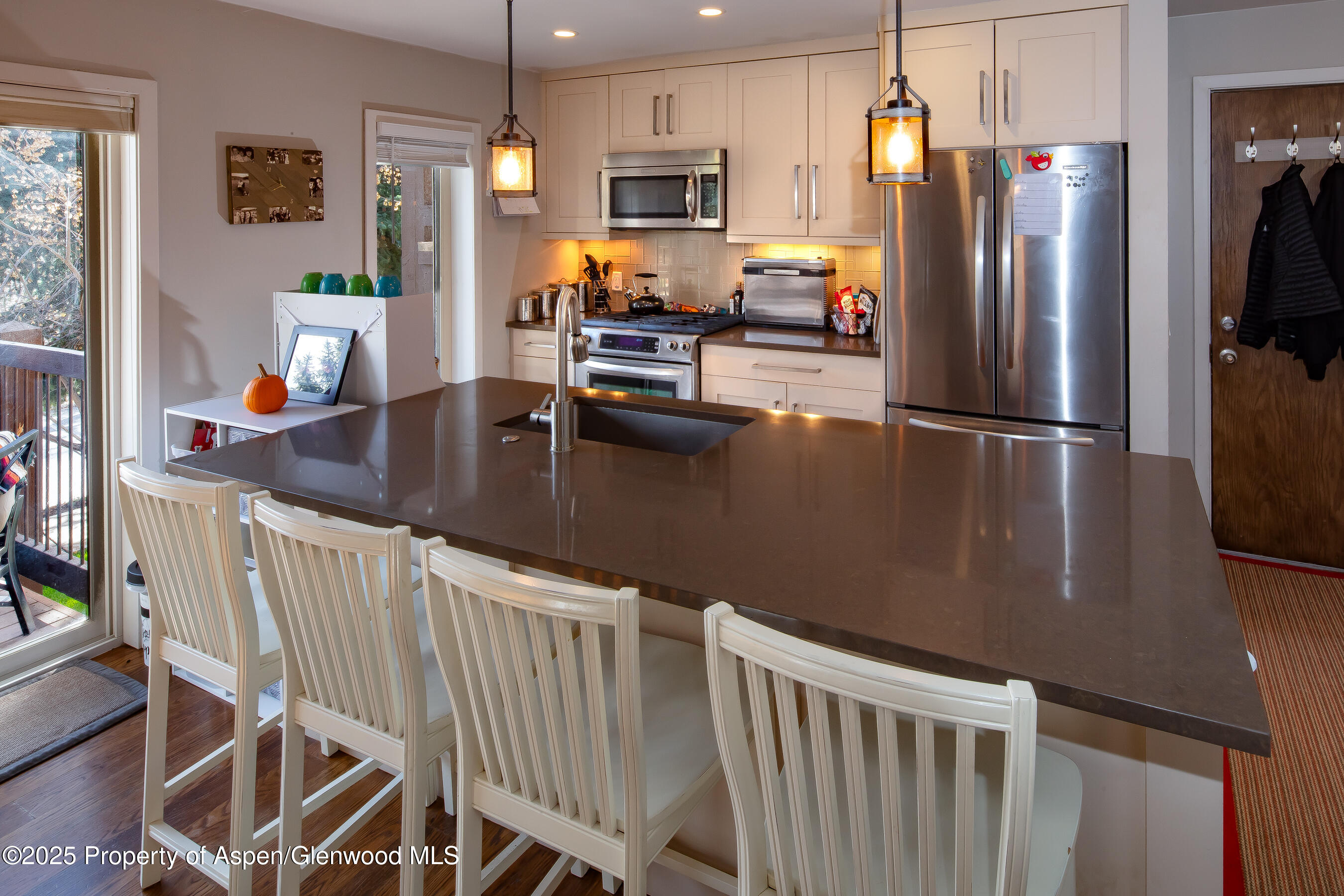 35 Upper Woodbridge Road, Unit 28A Snowmass Village, CO 81615 - Photo 5 of 13 a kitchen with stainless steel appliances granite countertop a refrigerator a stove top oven a sink dishwasher and white cabinets