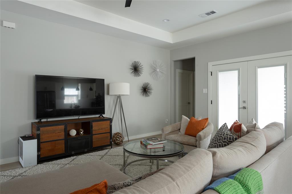 1108 Claude Street Dallas, TX 75203 - Photo 4 of 17 Living area featuring a tray ceiling, recessed lighting, and light wood-finish flooring