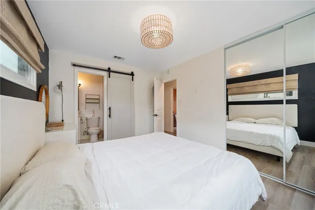 a bedroom with a bed and a chandelier