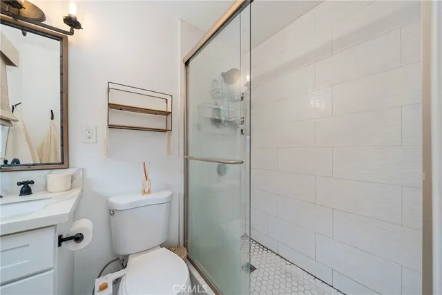 a bathroom with a toilet and a shower
