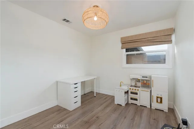 a room with a wooden floor and a window
