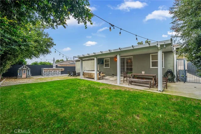 a front view of a house with a garden and patio