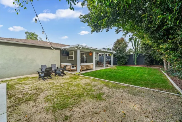 a view of a house with backyard porch and sitting area