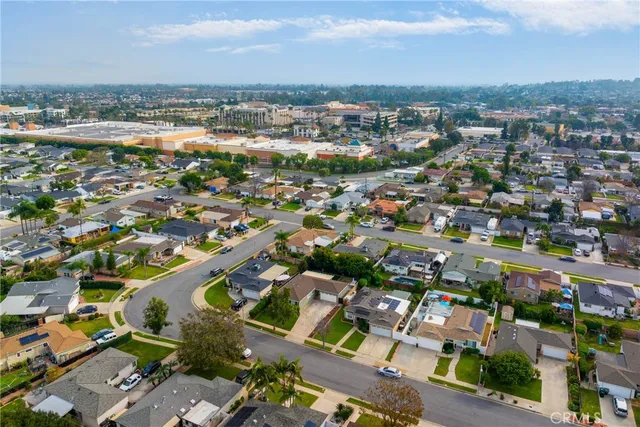 an aerial view of residential houses with city view