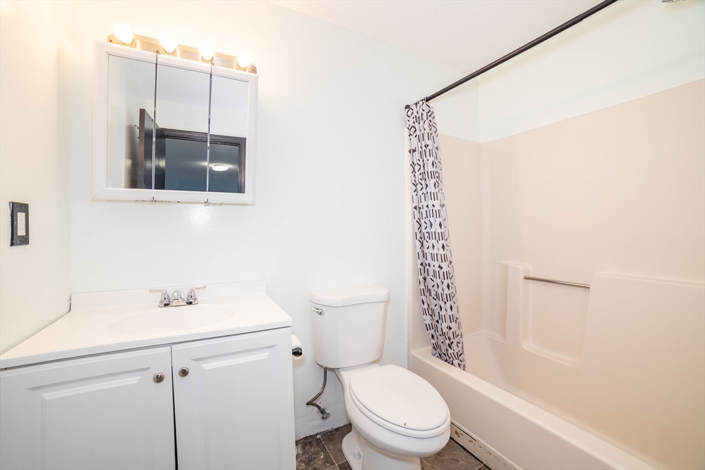 80 Stanton Street, Unit 32 Worcester, MA 01605 - Photo 14 of 20 a bathroom with a sink a toilet and shower