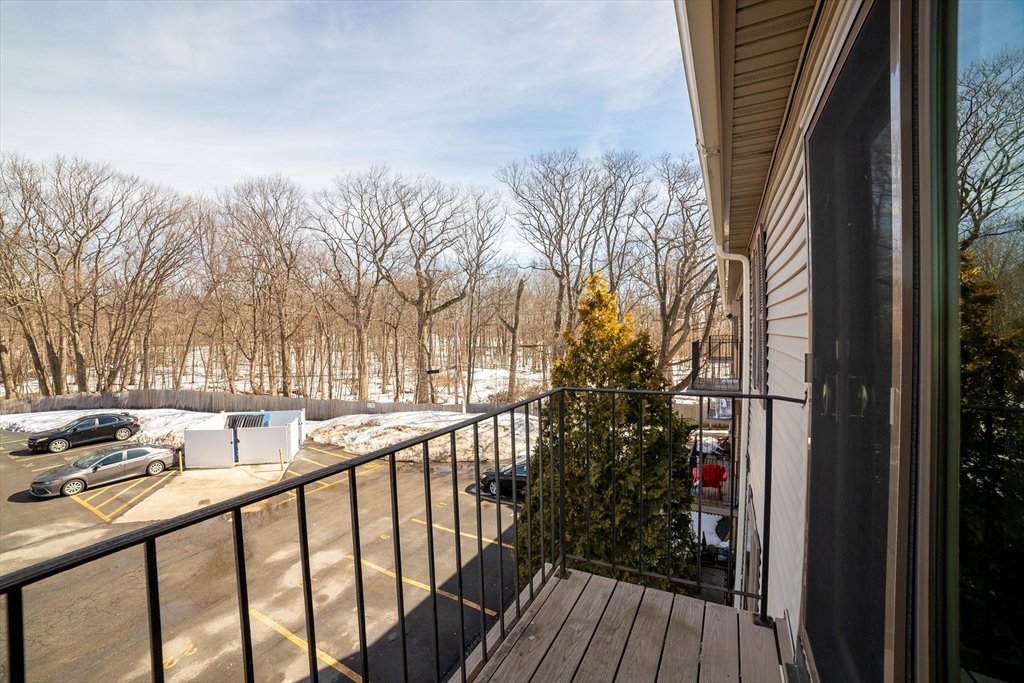 80 Stanton Street, Unit 32 Worcester, MA 01605 - Photo 3 of 20 a view of balcony with wooden floor and fence