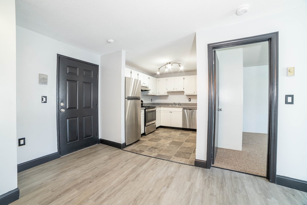 80 Stanton Street, Unit 32 Worcester, MA 01605 - Photo 8 of 20 a view of a kitchen with a sink and a refrigerator