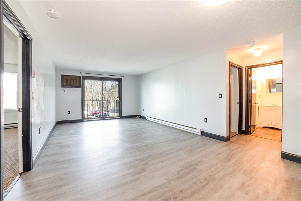 80 Stanton Street, Unit 32 Worcester, MA 01605 - Photo 10 of 20 a view of a big room with wooden floor and windows