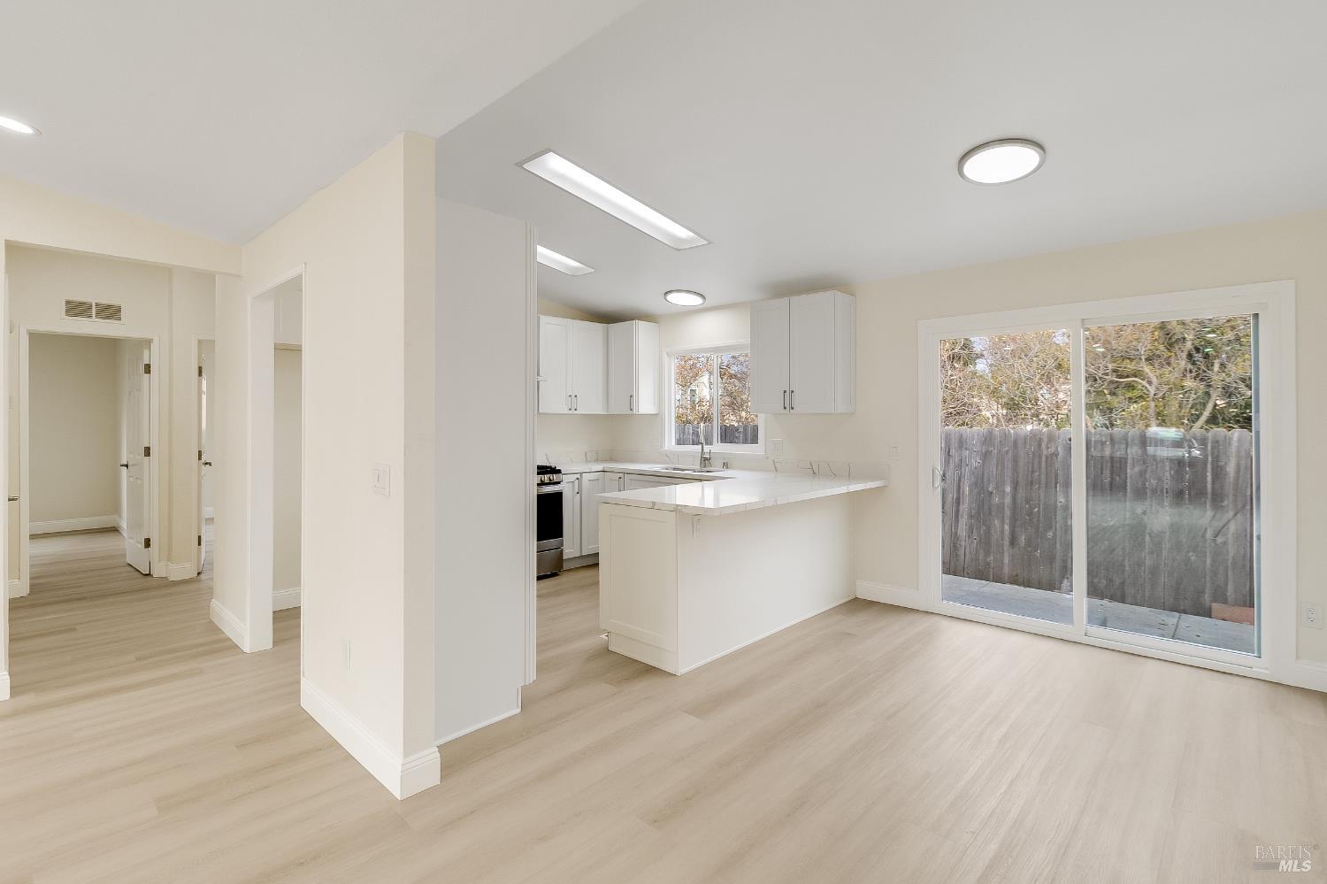 2555 Flosden Road, Unit 8 American Canyon, CA 94503 - Photo 13 of 58 a view of a kitchen with wooden floor and a window