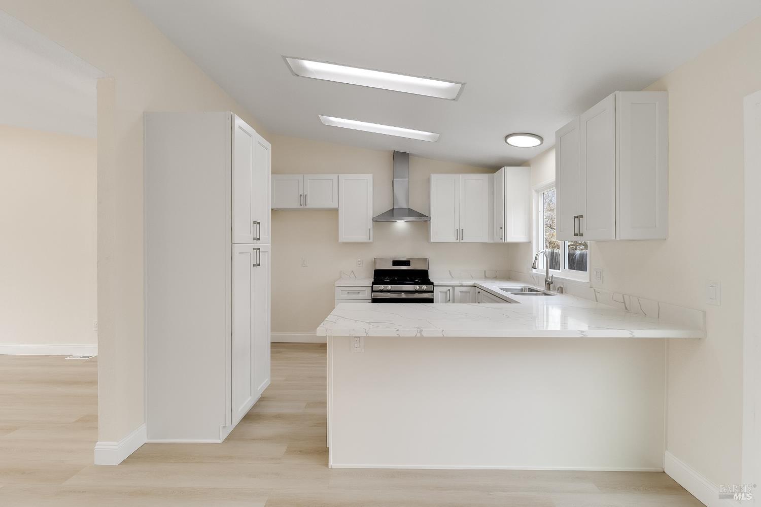 2555 Flosden Road, Unit 8 American Canyon, CA 94503 - Photo 14 of 58 a kitchen with stainless steel appliances a sink a stove a refrigerator cabinets and a dining table