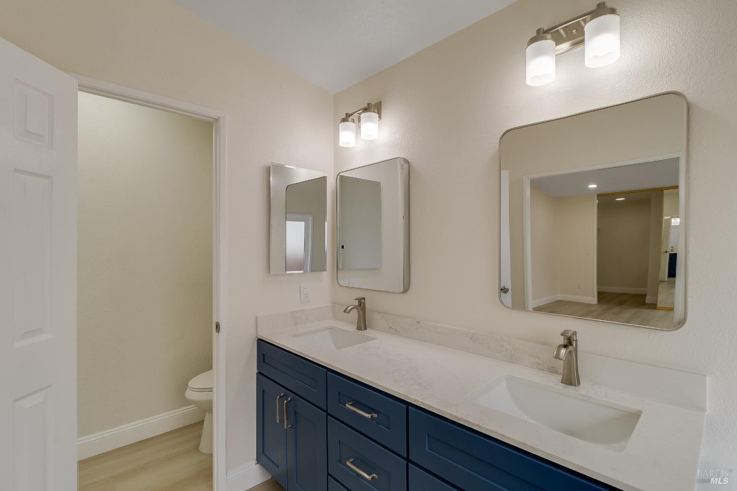 2555 Flosden Road, Unit 8 American Canyon, CA 94503 - Photo 27 of 58 a bathroom with a double vanity sink and a mirror