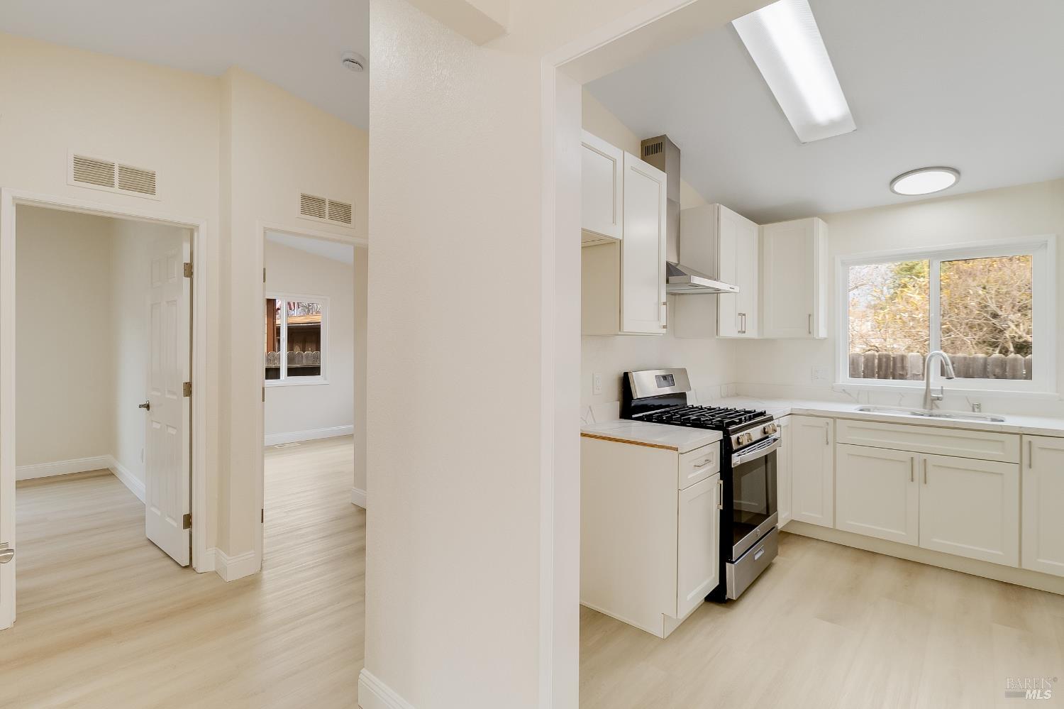 2555 Flosden Road, Unit 8 American Canyon, CA 94503 - Photo 29 of 58 a kitchen with stainless steel appliances granite countertop a stove a sink and a refrigerator