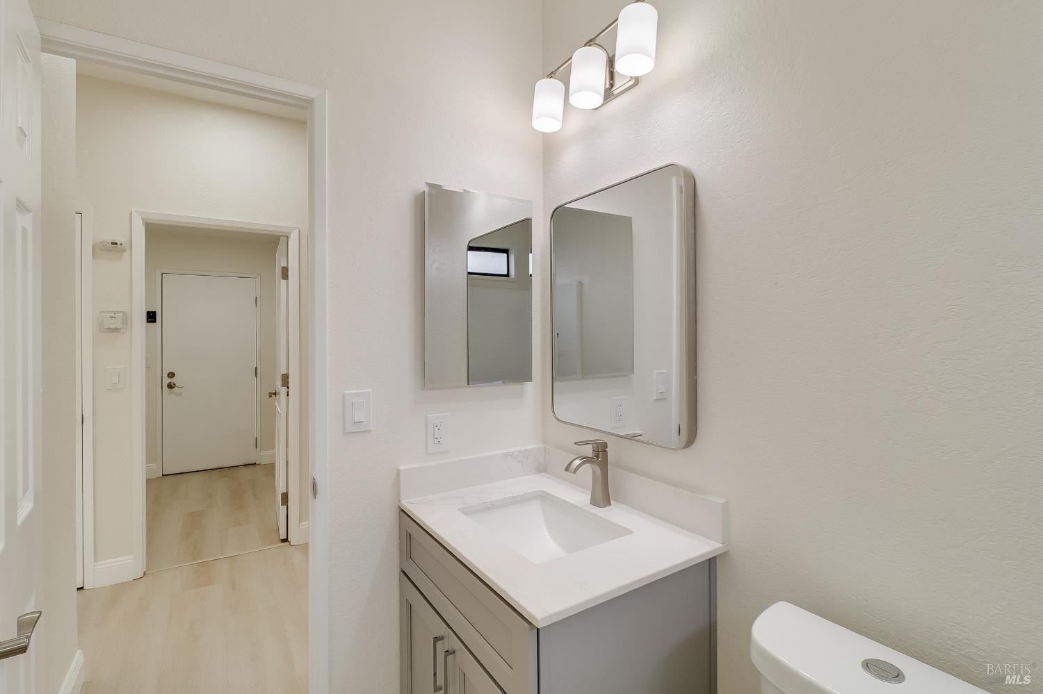 2555 Flosden Road, Unit 8 American Canyon, CA 94503 - Photo 32 of 58 a bathroom with a toilet a sink and mirror