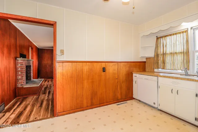 a kitchen with refrigerator a stove a washer and dryer
