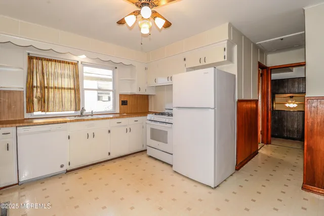 a view of a bedroom with wooden floor and a window