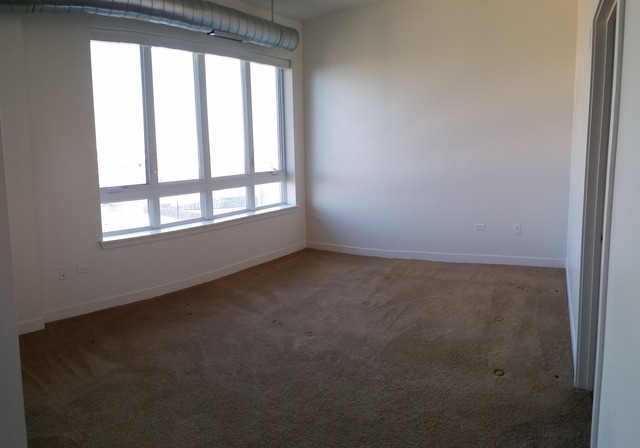 450 Village Center Drive, Unit 414 Burr Ridge, IL 60527 - Photo 8 of 10 an empty room with a window