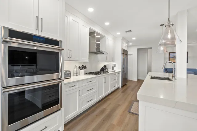a view of a dining room with furniture wooden floor and a chandelier