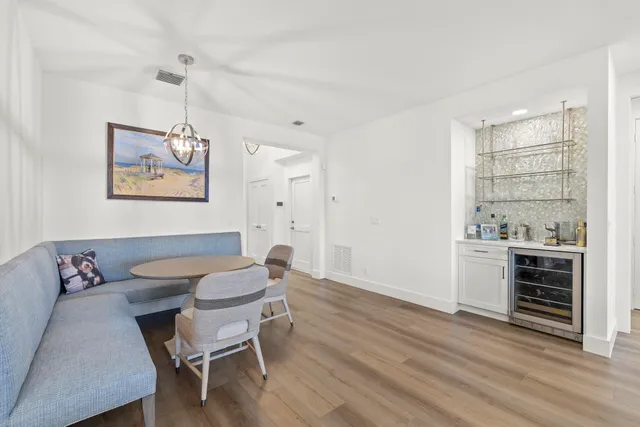 a bedroom with a large bed and a flat tv screen on dresser