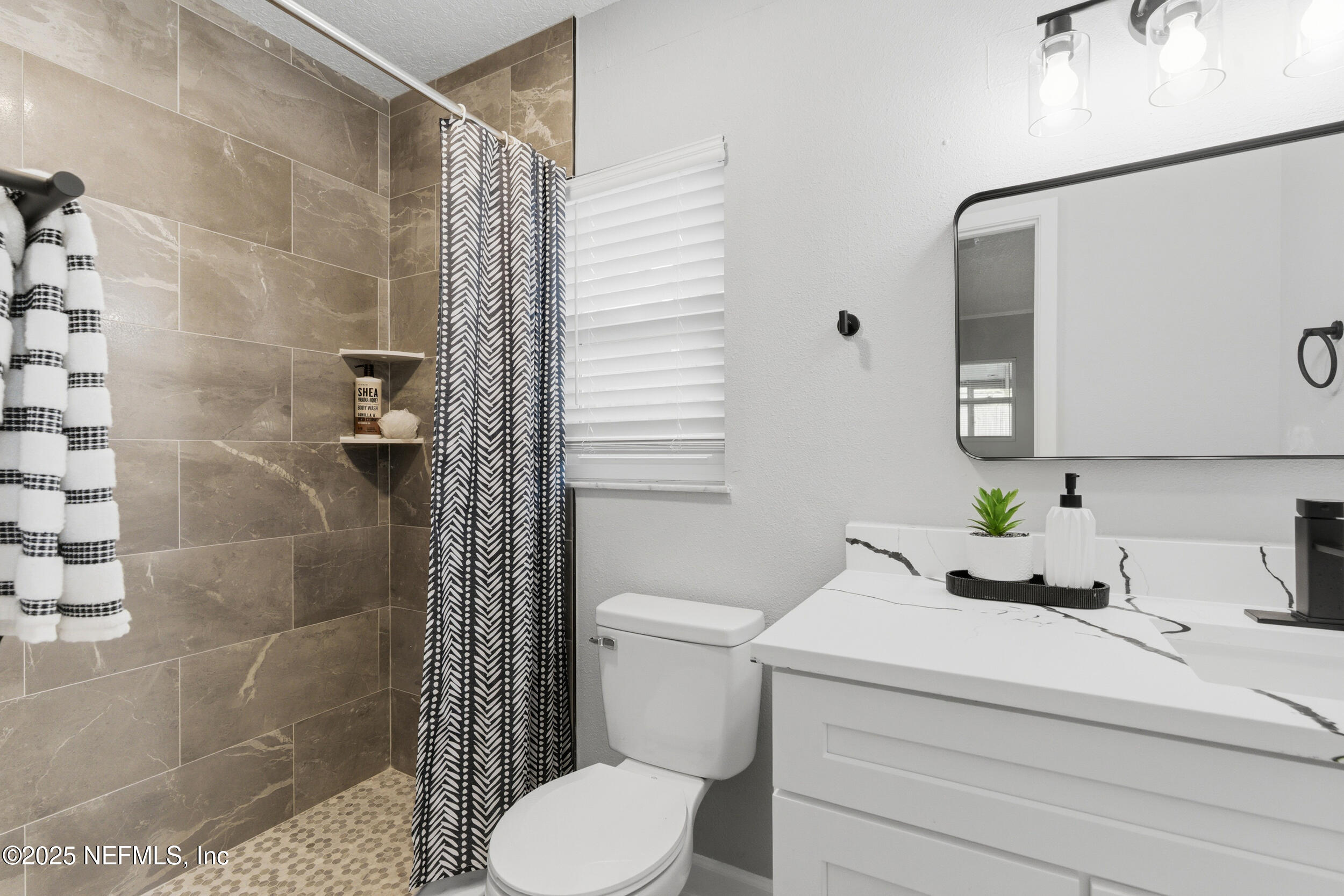 3631 North Ride Drive Jacksonville, FL 32223 - Photo 12 of 30 a bathroom with a sink toilet and shower