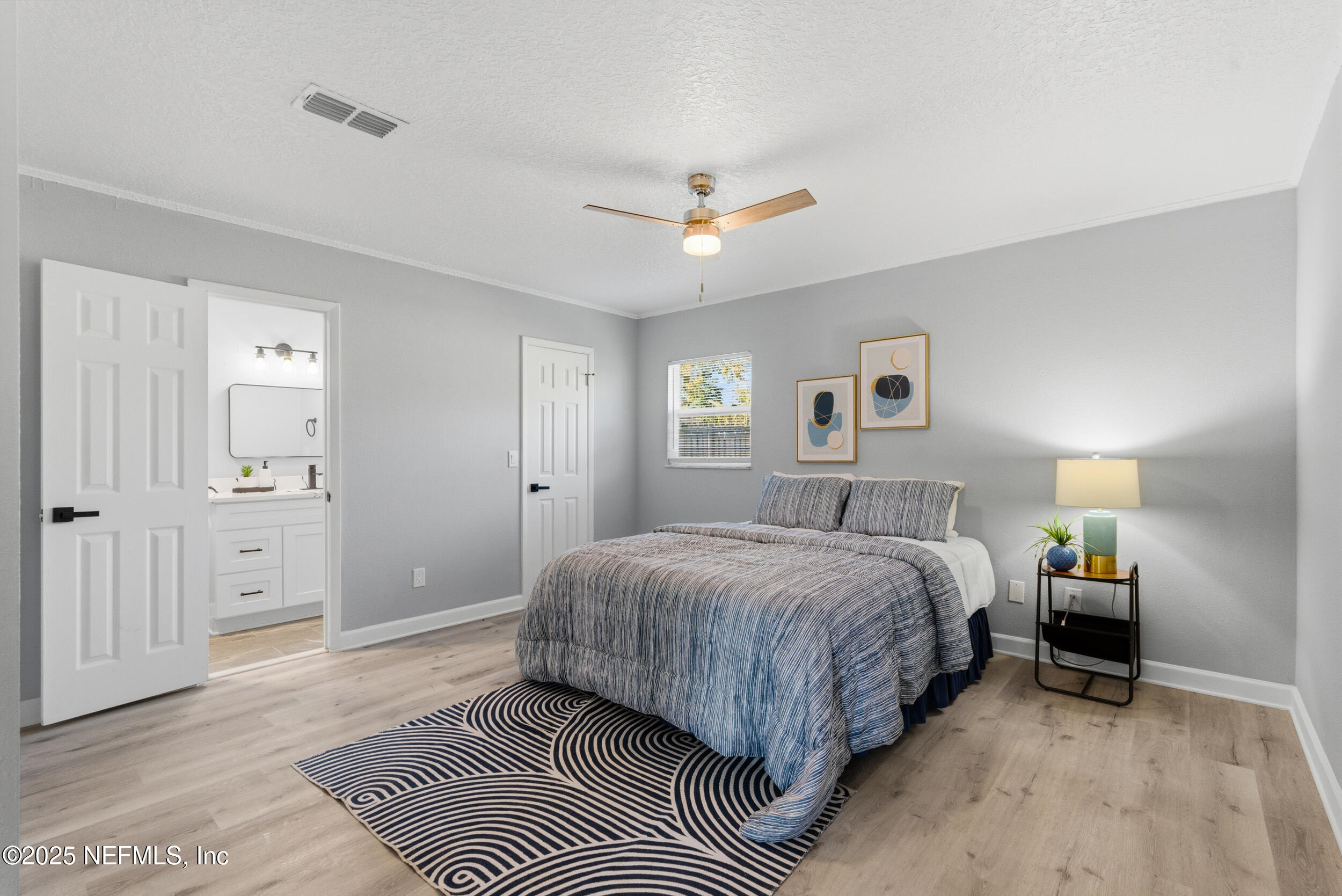 3631 North Ride Drive Jacksonville, FL 32223 - Photo 17 of 30 a spacious bedroom with a bed and a chandelier
