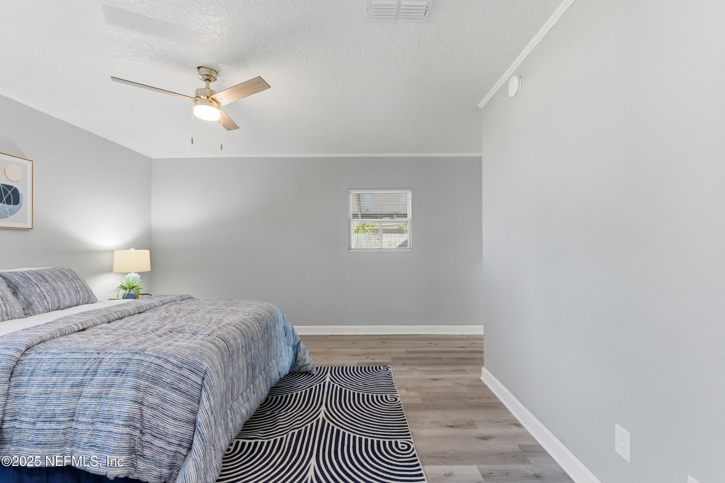 3631 North Ride Drive Jacksonville, FL 32223 - Photo 18 of 30 a bedroom with a bed and painting on the wall