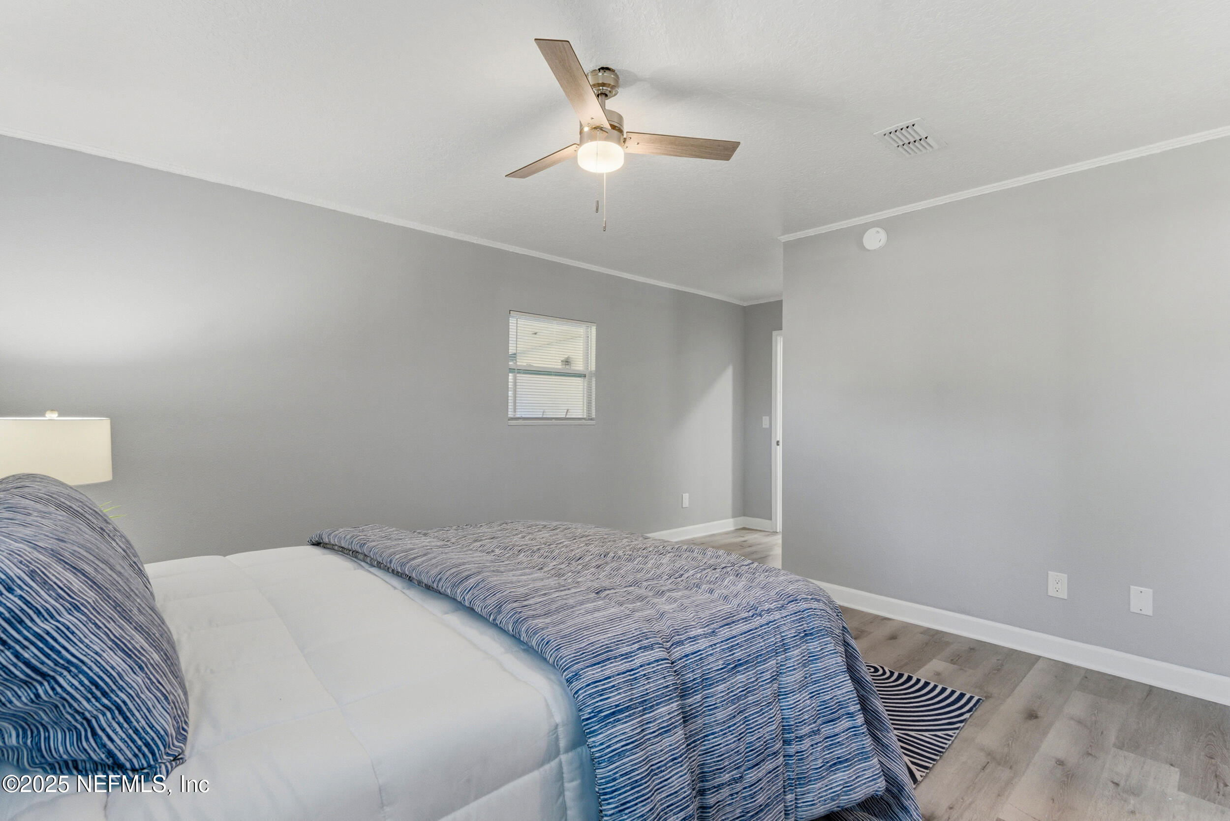 3631 North Ride Drive Jacksonville, FL 32223 - Photo 19 of 30 a bedroom with a large bed and a chandelier