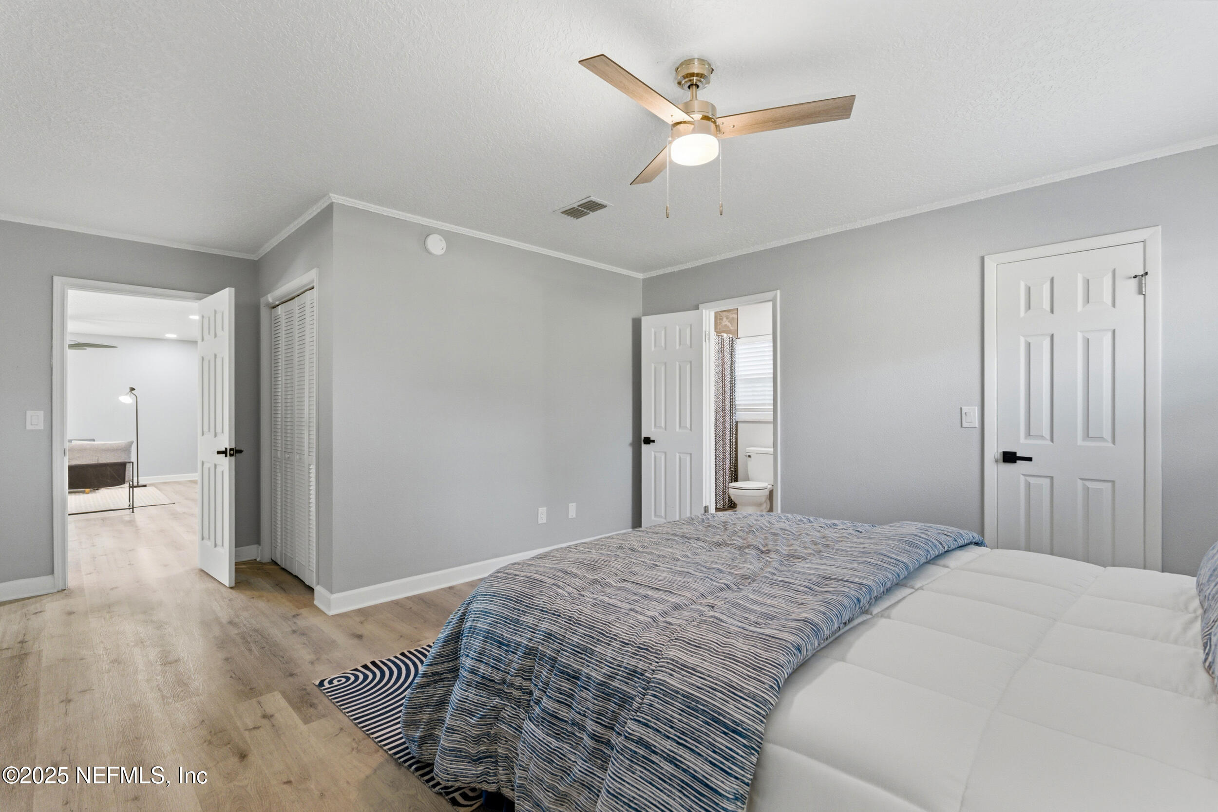 3631 North Ride Drive Jacksonville, FL 32223 - Photo 20 of 30 a bedroom with a large bed and a chandelier