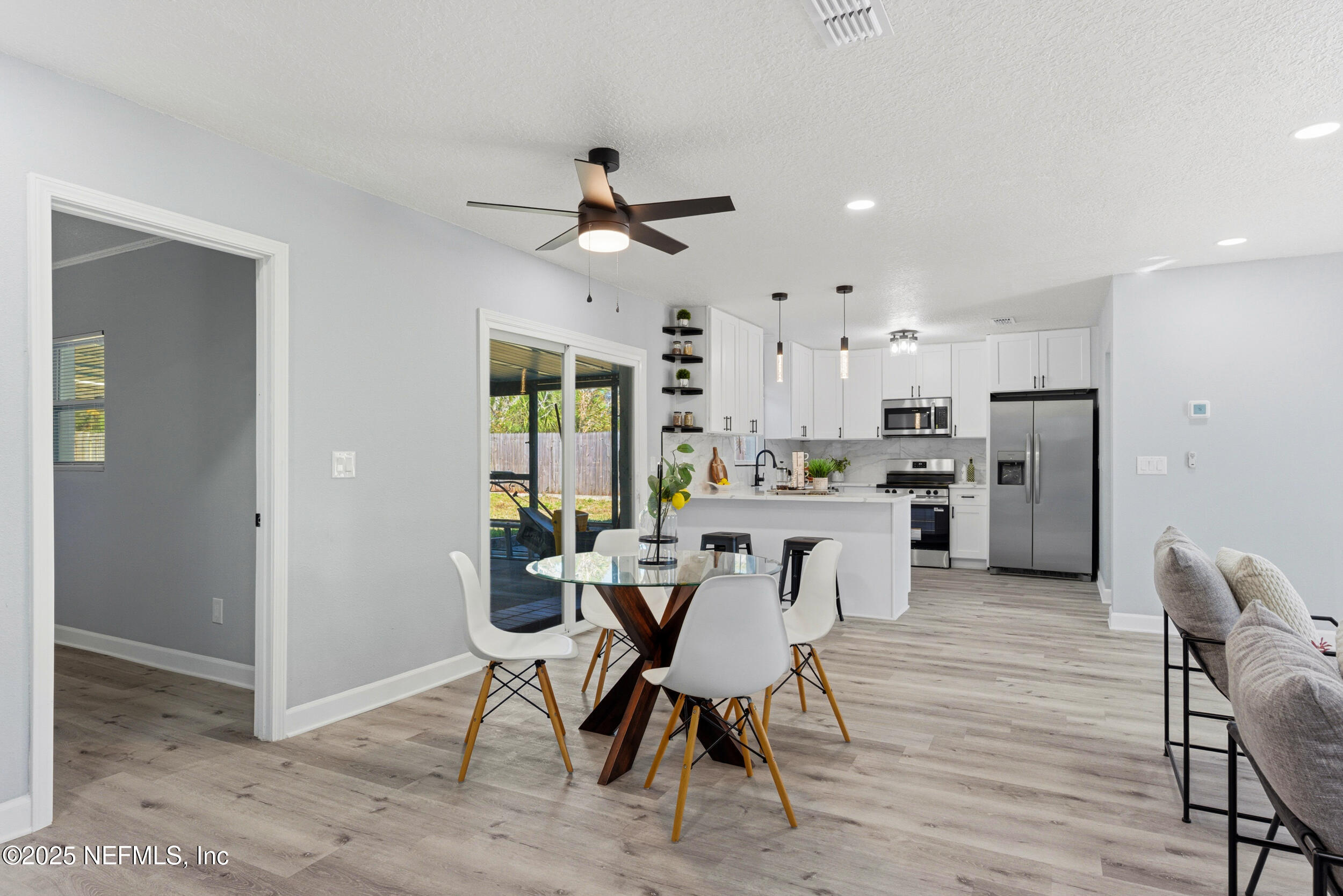 3631 North Ride Drive Jacksonville, FL 32223 - Photo 9 of 30 a view of a dining room with furniture and wooden floor