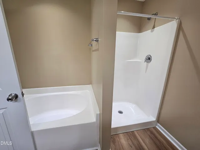 a bathroom with a double vanity sink and mirror with shower