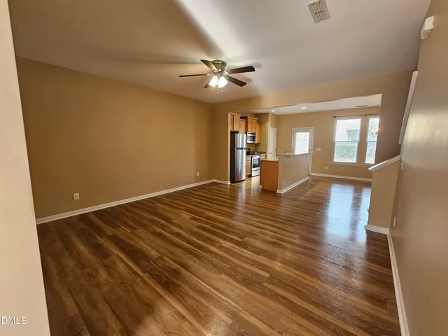 wooden floor in an empty room with a window