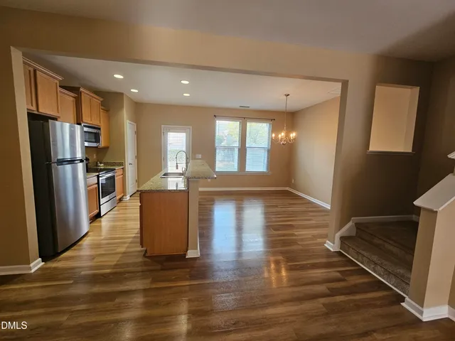 a view of kitchen with cabinets and wooden floor