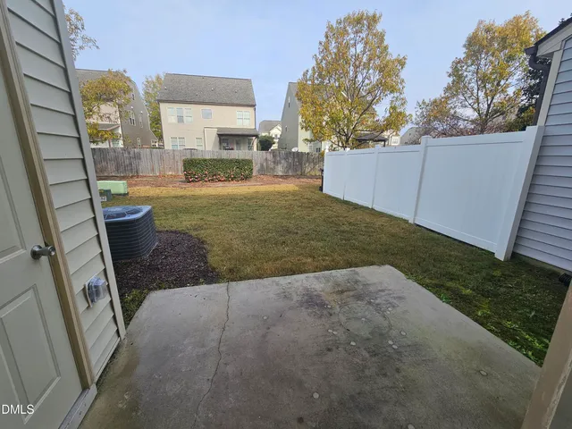a view of backyard of house and entertaining space