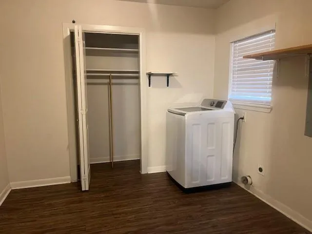 a view of a room with wooden floor and cabinet