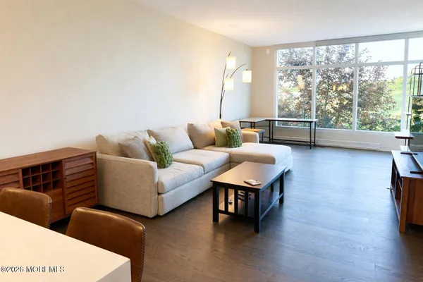 a living room with furniture and a large window