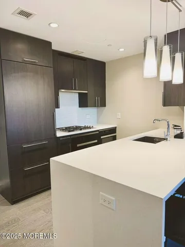 a kitchen with stainless steel appliances a refrigerator and a stove