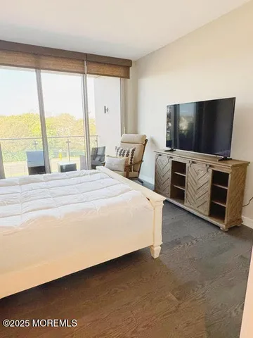 a view of an empty room with cabinet and door