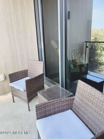 a living room with a couch and large window with outer view