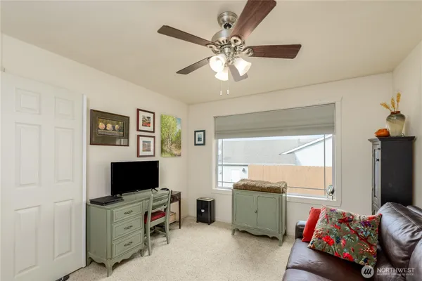 a bedroom with furniture and a flat screen tv