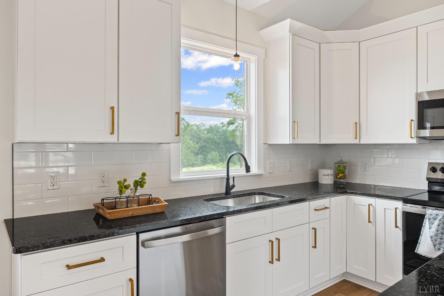 1 Kentmoor Farm Road Madison Heights, VA 24572 - Photo 11 of 38 a kitchen with stainless steel appliances white cabinets a stove a sink and a window