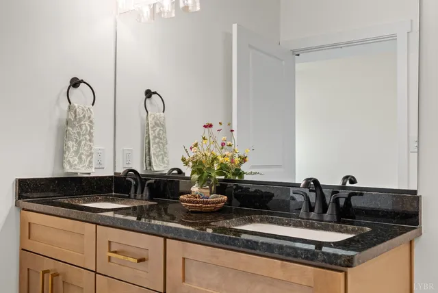 a bathroom with a double vanity sink and a mirror