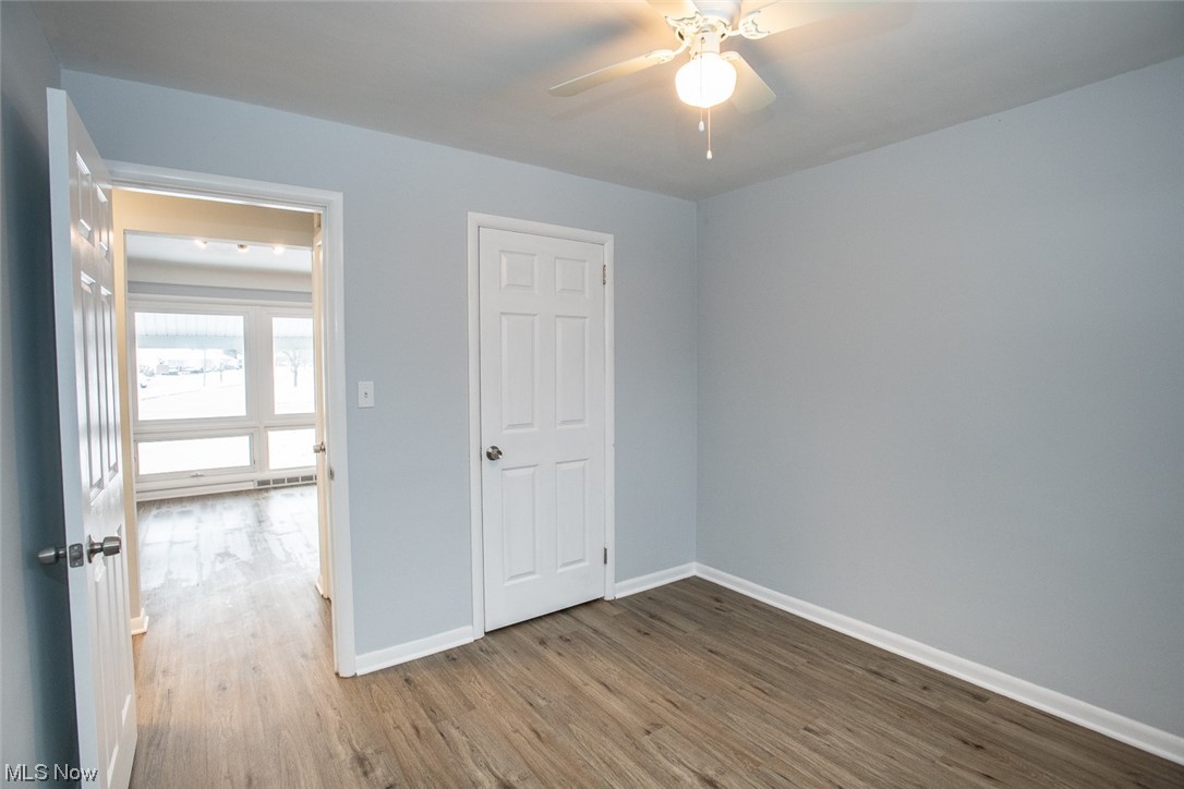 208 Greenvale Road Cleveland, OH 44121 - Photo 9 of 33 Empty room featuring dark wood-type flooring and ceiling fan